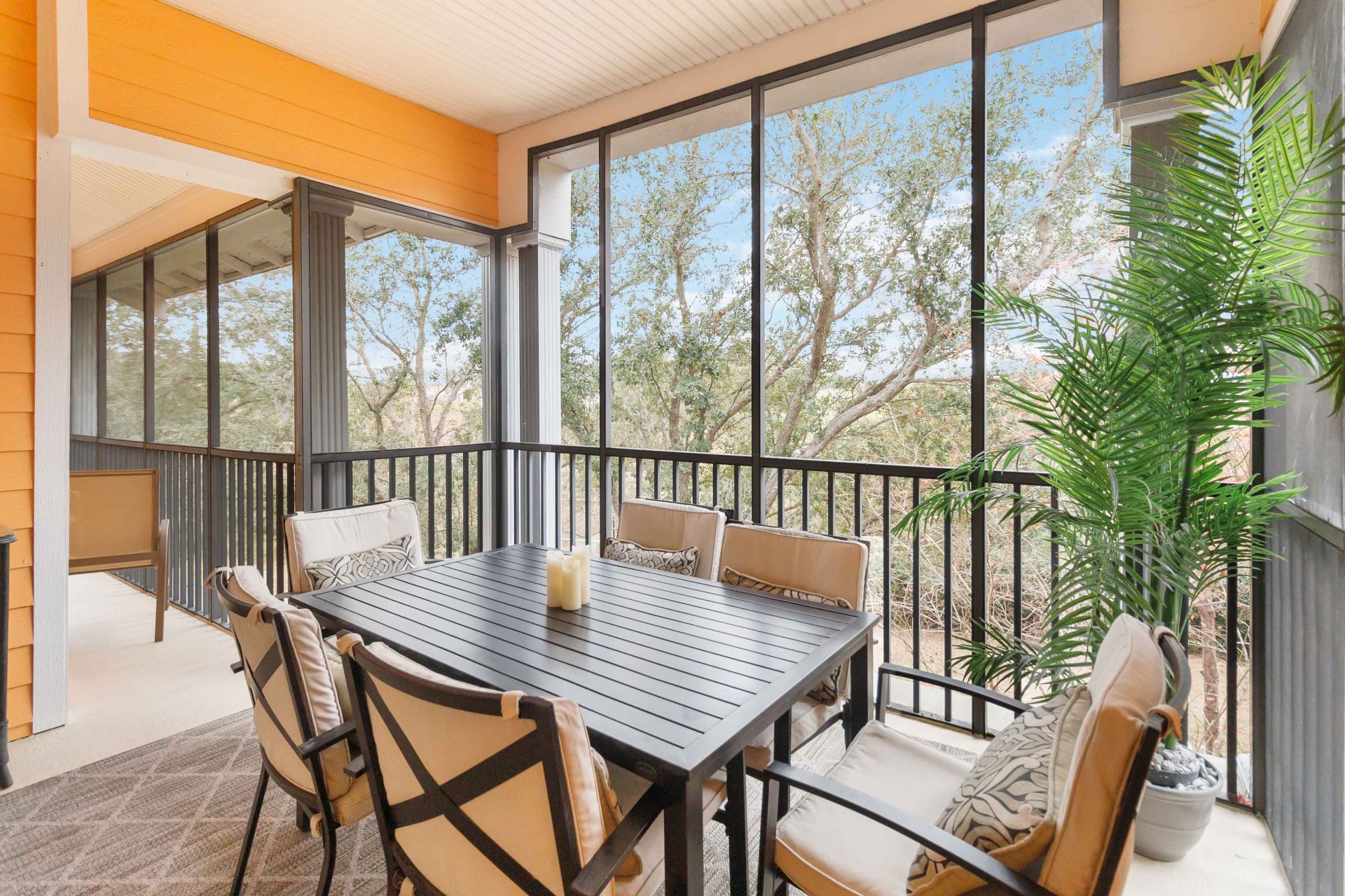 Balcony with dining table and screened views in the day