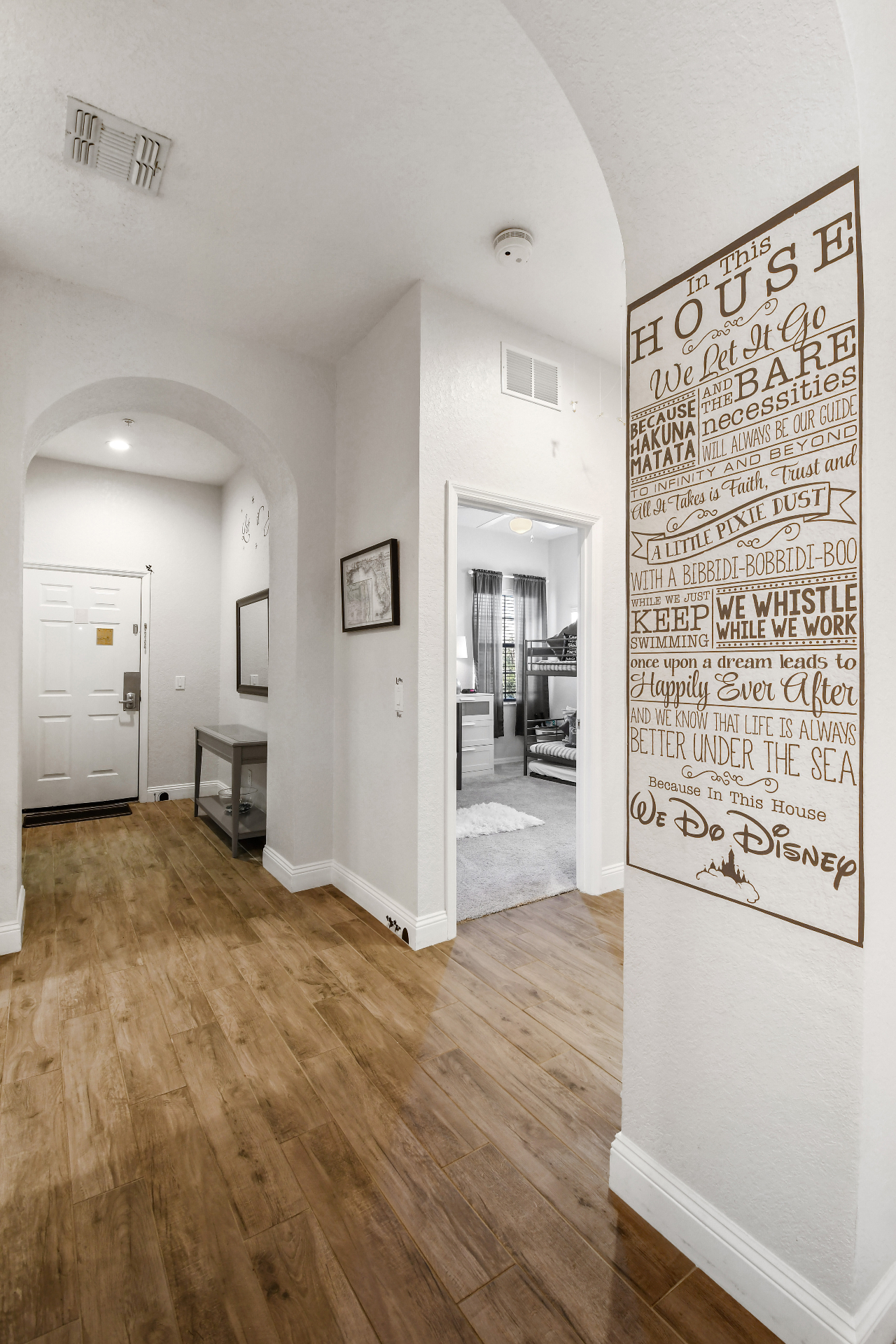 Hallway with 'In This House We Do Disney' feature wall