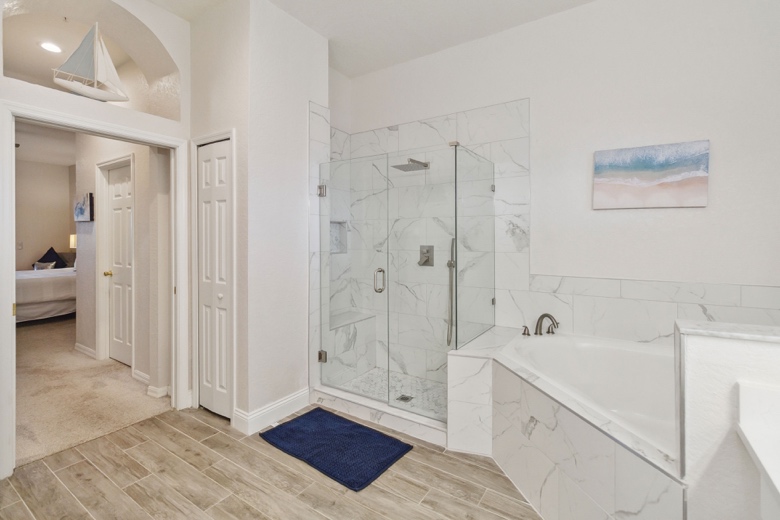 Master en-suite walk-in rainfall shower with marble tile