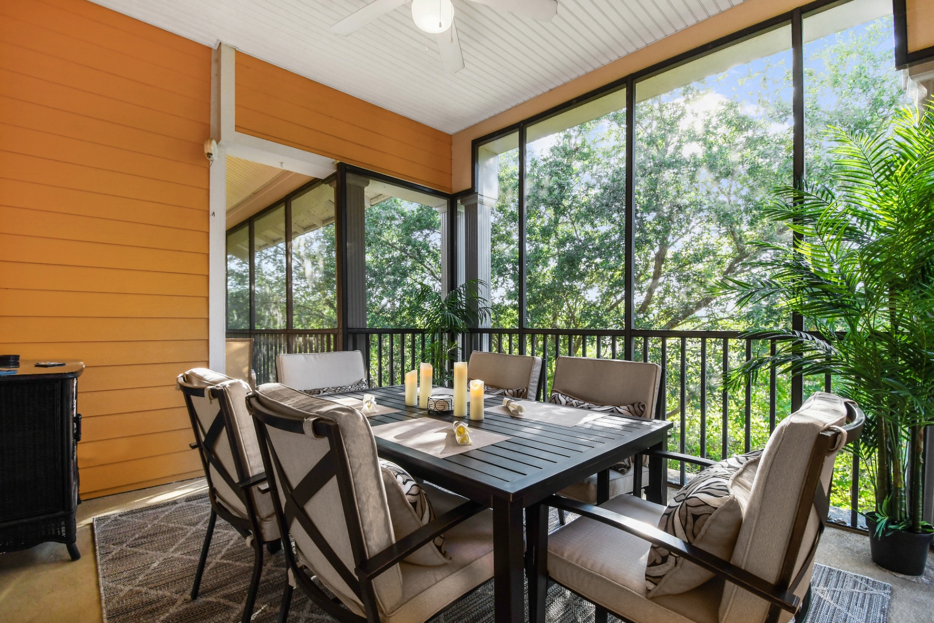 Screened balcony with dining table overlooking trees