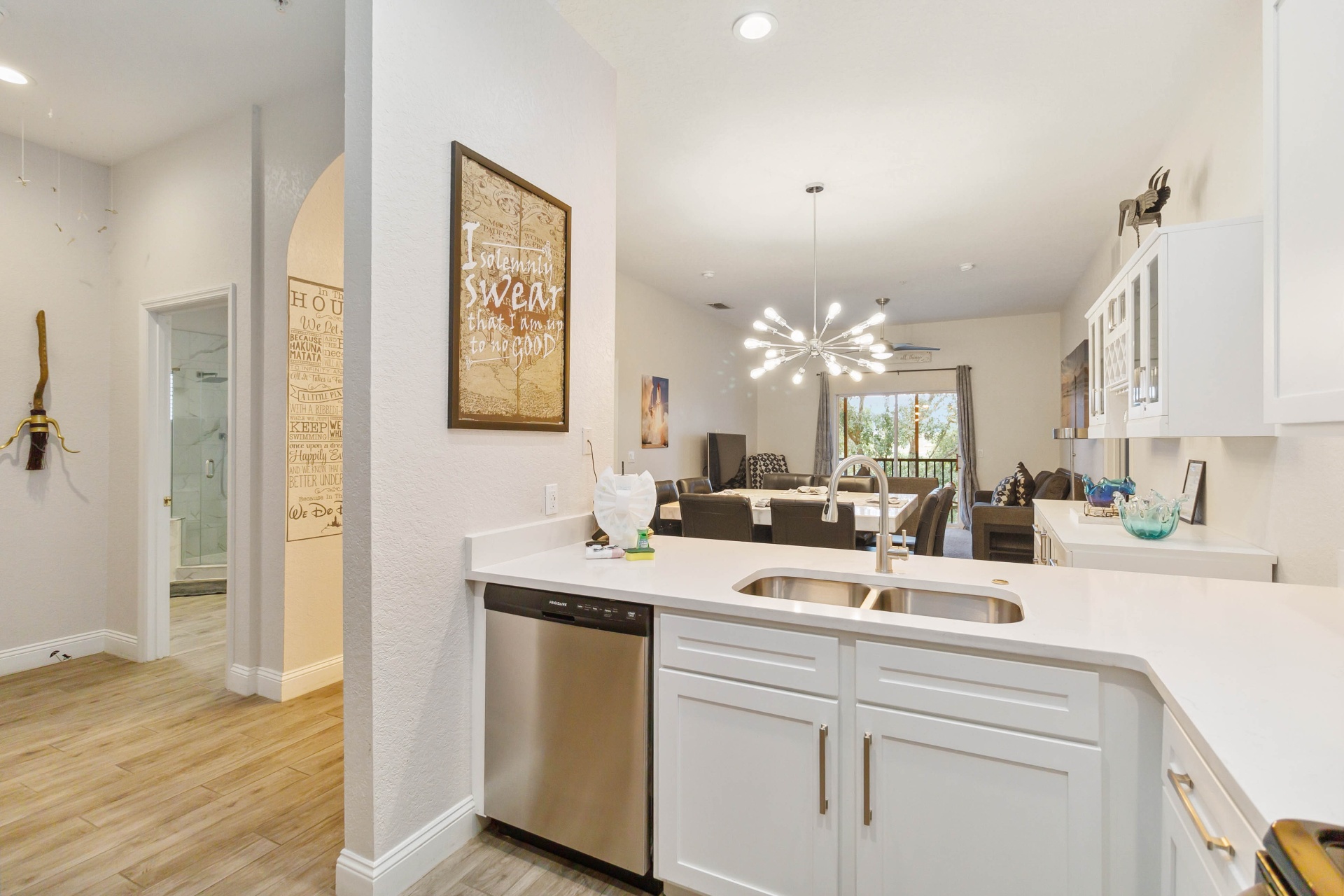 Kitchen area and hallway with white cabinetry
